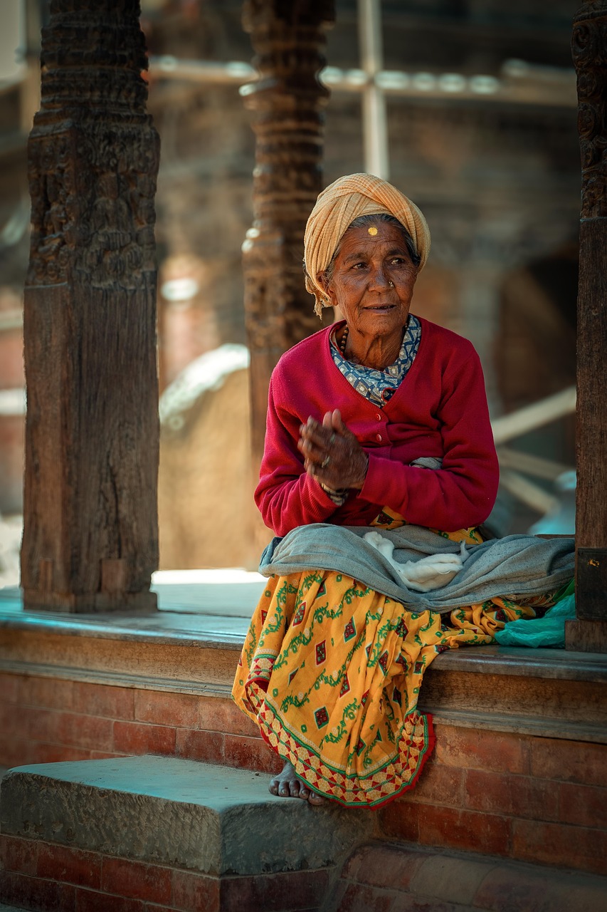 woman, elderly, red clothes, yellow skirt, nepal